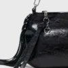 Bolso tipo riñonera Miss M de charol