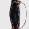Bolso tipo riñonera Miss M de charol